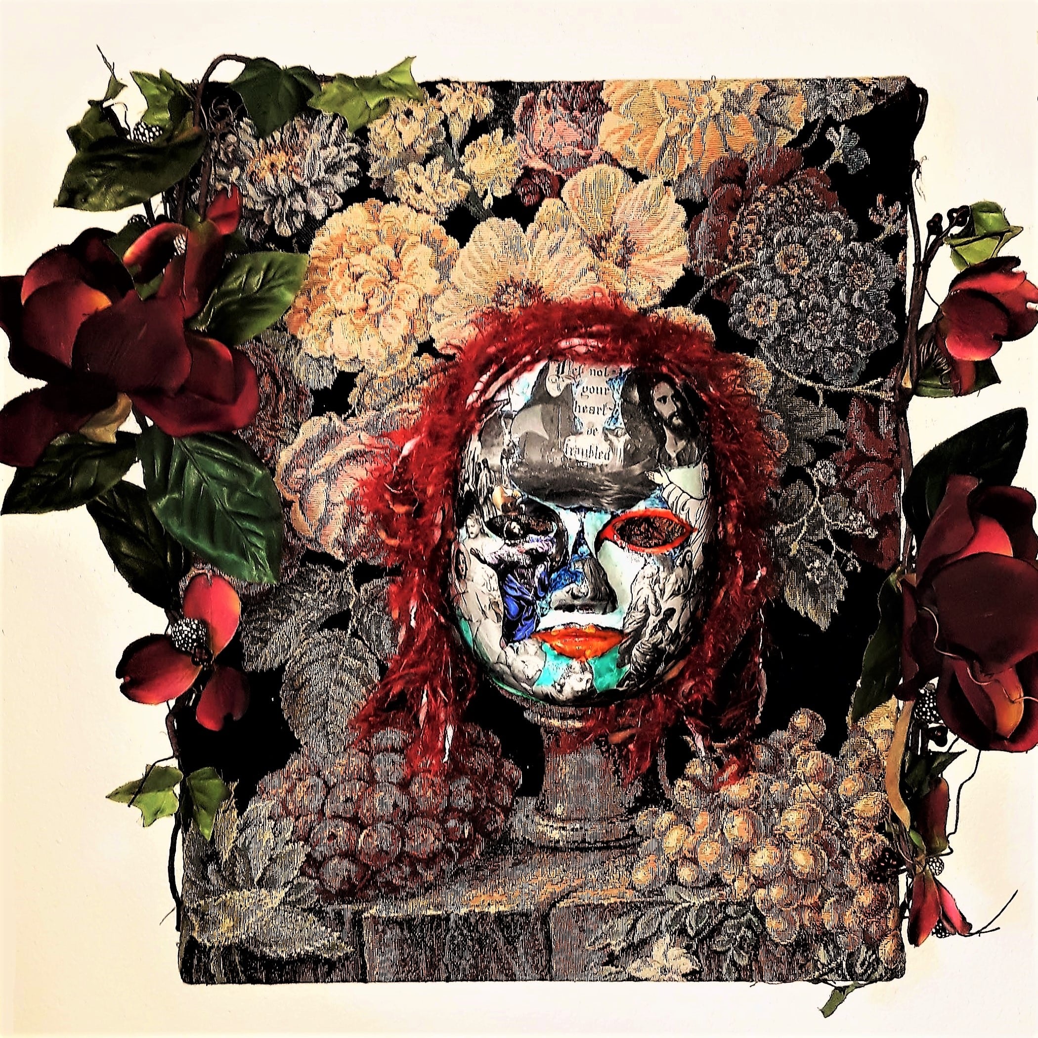 mask with red hair and images of fruit and tapestry surrounding it